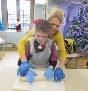 Student supported to make Christmas cake at Craig Y Parc School
