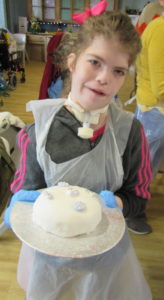 Student holding Christmas cake at Craig Y Parc School